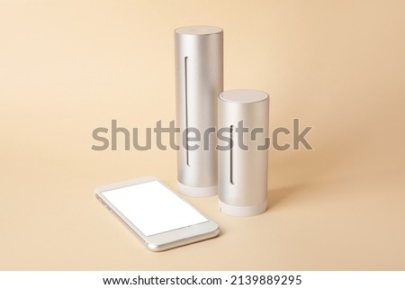 Digital weather station and mobile phone on color background