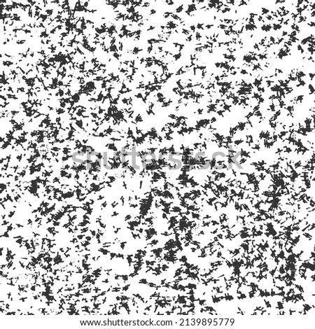 Particles or short fibers scattered on the white surface. Grunge background. Graphics in black and white.