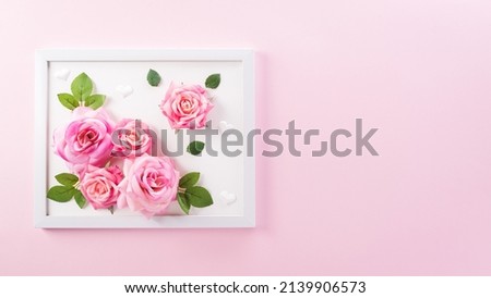 Happy Mother's Day decoration concept made from rose flower and picture frame on pink pastel background.