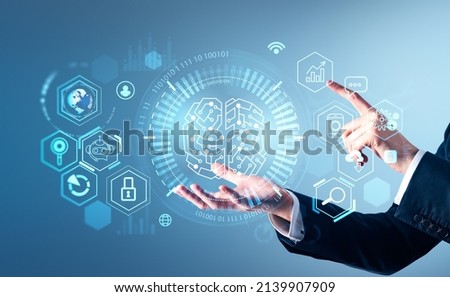 Businessman wearing formal suit is holding digital interface with hand. Hologram with binary code, circle hologram, virtual brain, globe on blue background. Concept of modern technology in business