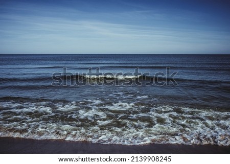 Tranquil seascape with calm sea and blue sky