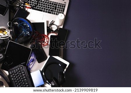 Old computers, digital tablets, mobile phones, many used electronic gadgets devices, broken household and appliances on gray background. Planned obsolescence, electronic waste for recycling concept Royalty-Free Stock Photo #2139909819