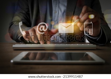 business  man CONTACT US (Customer Support Hotline people CONNECT ) phone application blue background to check mail hotline on computer