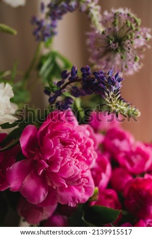 Beautiful floral background. Floral composition of fresh pink and white peonies as a decoration in the room.