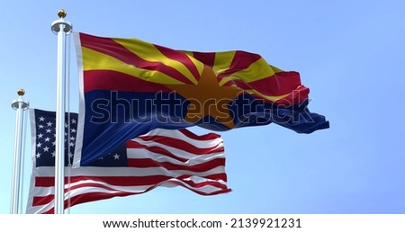 The flags of the Arizona state and United States waving in the wind. Democracy and independence. American state. Seamless 3D animation Royalty-Free Stock Photo #2139921231