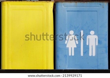 Rust color steel bucket with toilet sign