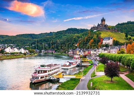 Cochem, Germany. Colored sunset with romantic Moselle River valley, Rhineland-Palatinate in red autumn colors. Royalty-Free Stock Photo #2139932731