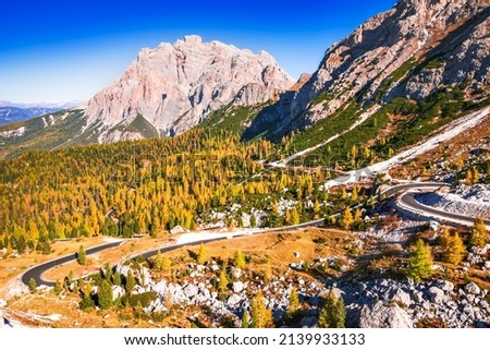 Passo Valparola, Italy. View of the serpentine in the Tyrol, Dolomite Alps. Mountain view Cima Cunturines (3.064 m) from Passo di Valparola with  in autumn near Cortina d'Ampezzo, Belluno in Italy Royalty-Free Stock Photo #2139933133