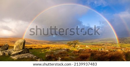Vibrant rainbows over Combestone Tor on Dartmoor Devon in the west country of England UK Royalty-Free Stock Photo #2139937483
