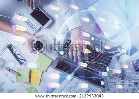 Multi exposure of man's hands typing over computer keyboard and world map hologram drawing. Top view. Technology concept.