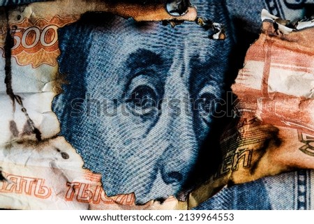 Benjamin Franklins face peeking out of a hole in a 5000 ruble banknote. High quality photo