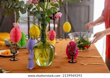woman sets the Easter table. for dinner. True lifestyle