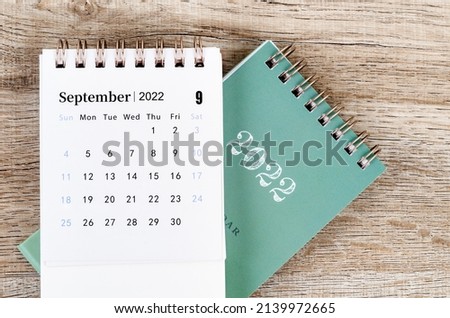 The September 2022 desk calendar on wooden background. Royalty-Free Stock Photo #2139972665