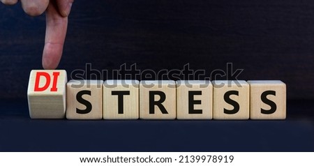 Distress or stress symbol. Turned the wooden cube and changed the concept word Distress to Stress. Beautiful grey table grey background, copy space. Psychlogical and stress or distress concept.
