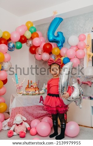  Girl with her birthday cake, happy birthday card, a cute little girl celebrates her birthday surrounded by gifts. High-quality photo