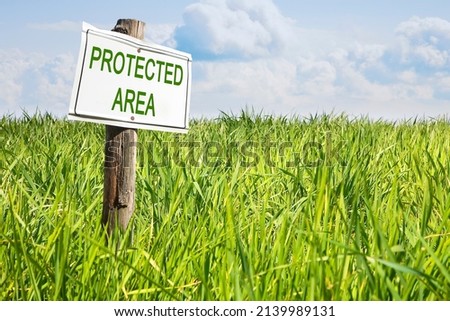 Protected area written on a field sign - Sign indicating in the countryside - Agricultural concept