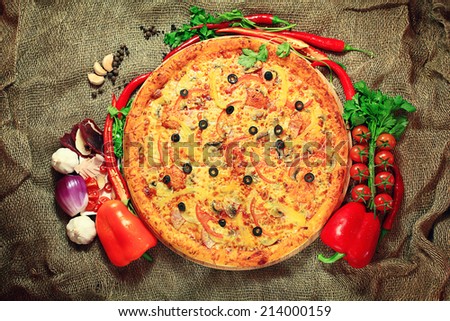 pizza with vegetables and herbs rustic background
