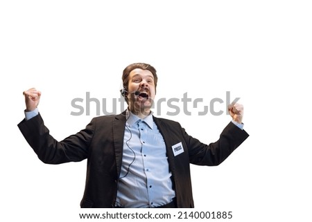 Emotive young man, professional sport commentator, journalist with microphone broadcasting football match isolated over white background. Sport, news, information. Copy space for ad Royalty-Free Stock Photo #2140001885