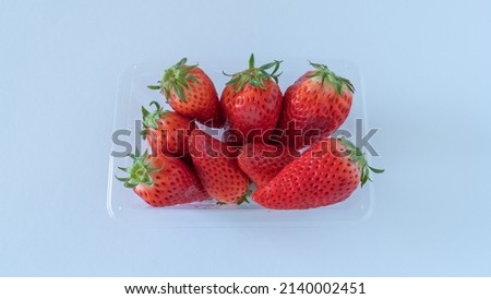 Strawberries in a plastic container.