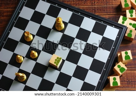 wood block with group of people icon on chess board game