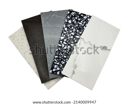 different quartz samples swatch for kitchen counter top with precise processed edges isolated on background with clipping path. multi color and pattern of artificial stones (focused at black pebble). Royalty-Free Stock Photo #2140009947