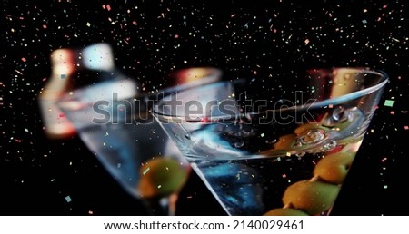 Image of confetti falling over cocktails. world cocktail day and celebration concept digitally generated image.