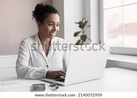 Young woman using laptop computer at home. African american student girl using laptop. Technology, business, distance studying, meeting online, learning, internet marketing, entrepreneur concept Royalty-Free Stock Photo #2140032909