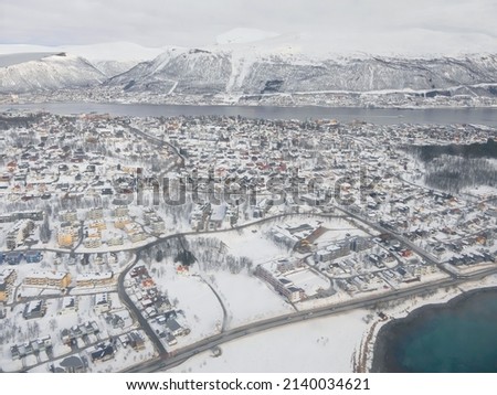 Aerial view of white snow covered city Tromso Norway winter, colorful building wallpaper