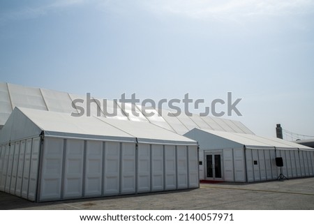 Installation of the huge tent Size 40m. to 120 m under a sunny sky Suitable for all events Royalty-Free Stock Photo #2140057971