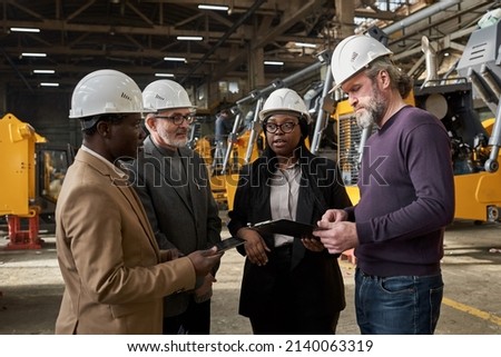 Delegation of business people working in plant