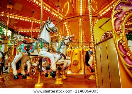 Carousel with colorful horses at amusement park, Merry go round with horse, Vintage ride attraction for children Royalty-Free Stock Photo #2140064003