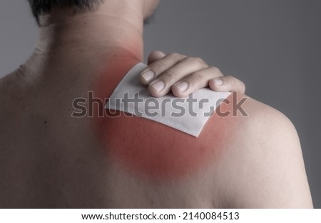 Medicated pain relief patch with man pain shoulders,office syndrome,Health problems from overworked concept. Royalty-Free Stock Photo #2140084513
