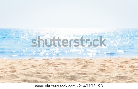 Panorama of a beautiful white sand beach and turquoise water in Maldives. Blur bokeh light of calm sea and sky. Focus on sand foreground.