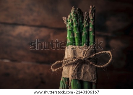 closeup rustic picture of a lovely bunch of fresh sparrow grass wrapped and tied with a rope 