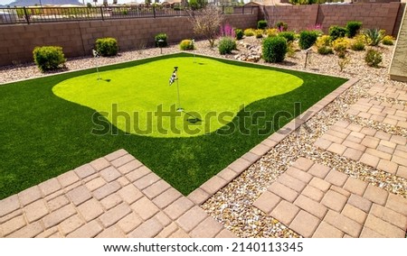 Putting Green In Rear Yard Setting Royalty-Free Stock Photo #2140113345
