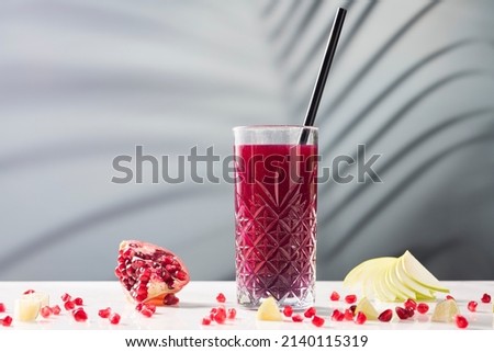 Fruit juice, pomegranate juice on a marble table, on a soft focus background Royalty-Free Stock Photo #2140115319