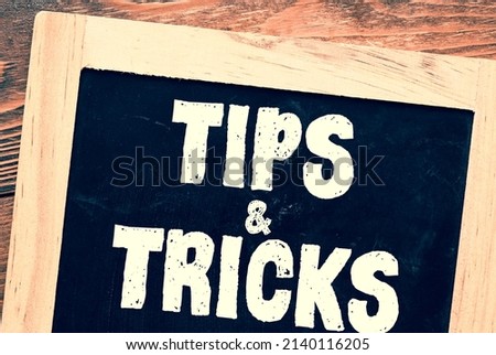 TIPS AND TRICKS words on a chalkboard.