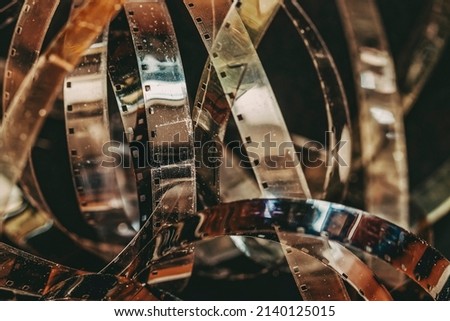 Aged dirty movie film rolls, retro reels, filmstrip, photographic film, shallow depth of field., selective focus. Vintage background, retro style. Photo, movie cinema concept