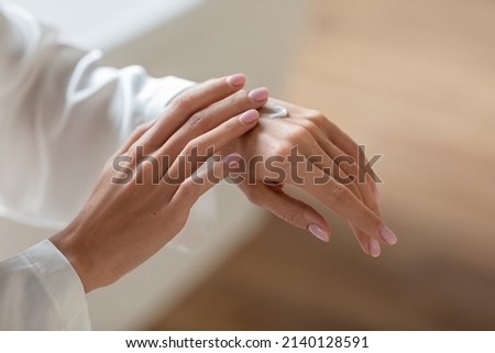 Dry Skin Remedy. Unrecognizable Young Woman Applying Hand Cream, Closeup Shot Of Female Rubbing Moisturising Body Lotion On Arms After Bath, Making Beauty Treatments At Home, Cropped Image Royalty-Free Stock Photo #2140128591