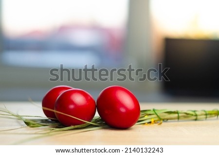 red eggs and basket with white space of wood
