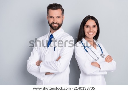 Photo of two positive professional doctors folded arms look camera isolated on grey color background Royalty-Free Stock Photo #2140133705