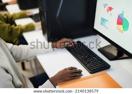 Hands view of young african student using computer inside college room at school university - Focus on right hand