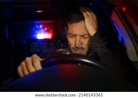 Road police car with flashing lights stopped man driver because of violation of traffic rules Royalty-Free Stock Photo #2140143365