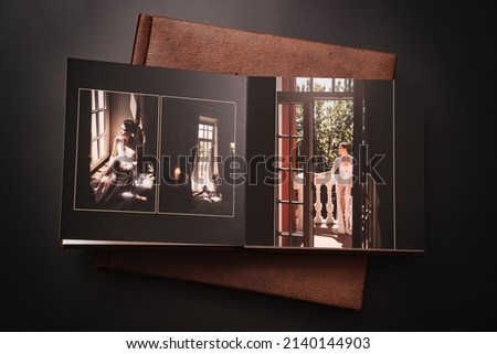 wedding photobooks in brown leather binding with photos of the newlyweds on the cover. high-quality and expensive photo and printing products. services of a professional photographer and designer.