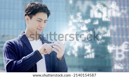 young asian man using smart phone online trading  Royalty-Free Stock Photo #2140154587