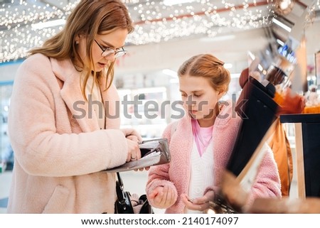 day of shopping daughter begs her mother for cash. High quality photo