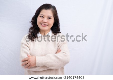 Portrait of senior Asian woman on white background Royalty-Free Stock Photo #2140176603