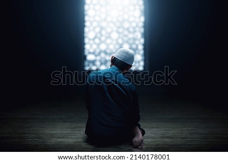 Muslim man praying in the mosque Royalty-Free Stock Photo #2140178001