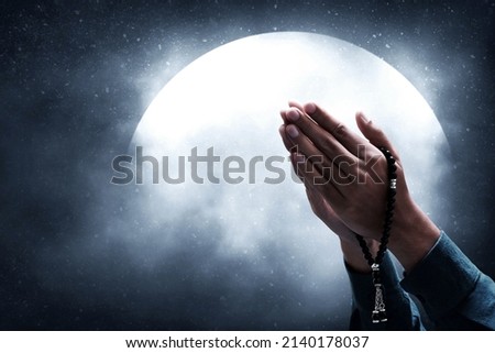 Muslim man praying on night sky moon Royalty-Free Stock Photo #2140178037
