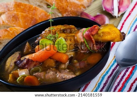 Image of tasty scottish traditional soup cock-a-leekie with chicken, bacon and leek Royalty-Free Stock Photo #2140181559